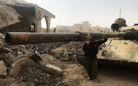 A member of the Syrian pro-government forces next to a tank in the eastern city of Deir ez-Zor on November 4, 2017. File photo: AFP via Getty Images