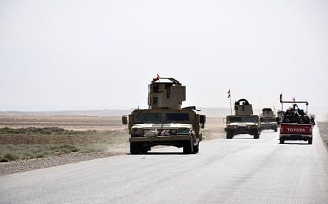Iraqi army forces drive down a road, linking Hawija to Kirkuk, near the village of Khabbaz in October 2017. Photo: AFP /Marwan Ibrahim