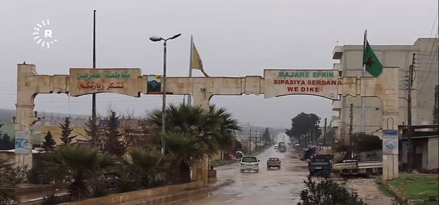 A sign reads 'Welcome to the city of Afrin' in Kurdish and Arabic, in northwestern Syria's Aleppo province on February 19, 2018.