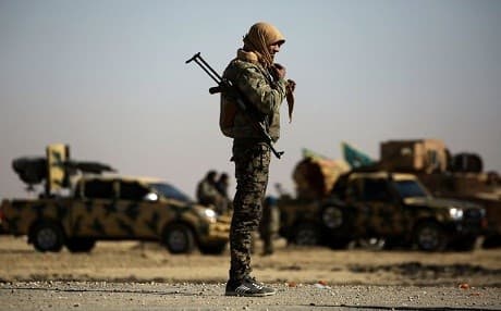 A fighter in the Syrian Democratic Forces near a village northeast of Raqqa in February 2017. Photo: Delil Souleiman | AFP