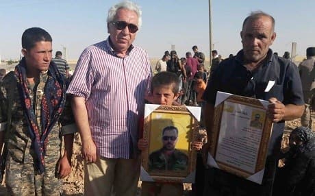 Omar Alloush, center, pictured in June 2017 standing next to family members of a fighter from the Syrian Democratic Forces who was killed in battle against ISIS in Raqqa. Photo: Omar Alloush/AP
