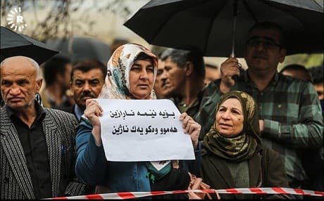 A woman in Sulaimani holds a sign reading 'We are dissenting because not everyone lives the same' on March 25, 2018. Photo: Sartip Othman