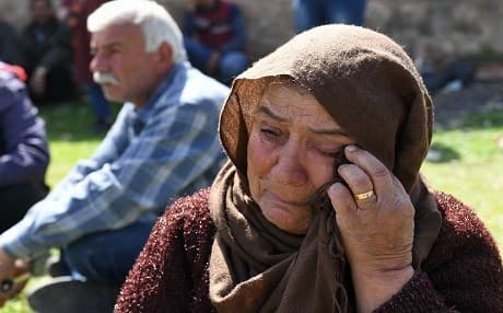 A Kurdish woman cries as they gather on Newroz in the village Fafin in northern Aleppo on March 21, 2018. Photo: George Ourfalian | AFP
