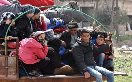 Syrians displaced from the city of Afrin with their belongings in the northern Aleppo town of Tal Rifaat on March 28, 2018. Photo: George Ourfalian | AFP