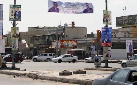 A picture taken on April 14, 2018 in the city of Basra shows campaign billboards for Iraqi candidates in the upcoming parliamentary elections. Around 7,000 candidates have registered to stand in the May 12 election, with 329 parliamentary seats up for grabs. Photo: AFP/Haidar Mohammed Ali