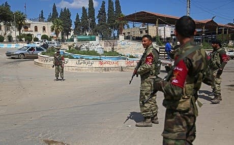Turkish-backed militiamen patrol a street in Afrin. Photo: Nazeer al-Khatib/AFP