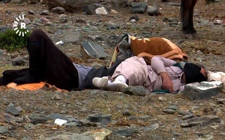 Kolbars rest while trekking goods from the Kurdistan Region to the Kurdish provinces of Iran. Photo: Rudaw TV