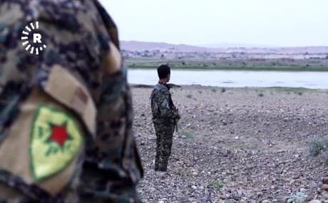 YPG members of the SDF look out over the Euphrates River in Deir ez-Zor. Photo: Rudaw