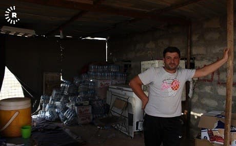 A Yezidi man stands outside a shop on Mount Shingal where hundreds of families who fled ISIS are still living in tents. Photo: Hannah Lynch/Rudaw