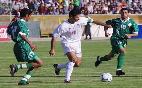 Iranian Ali Daei dribbles around Saudi national players at a qualifying match in Tehran for the 2002 World Cup. Photo: Behrouz Mehri | AFP
