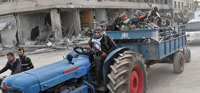 Syrian opposition forces looting the city of Afrin, March 19, 2018. Photo: AFP