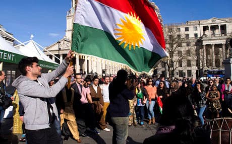 A Kurdish flag and dancers at the London flash mob. Photo: Jan Flisek-Boyle.