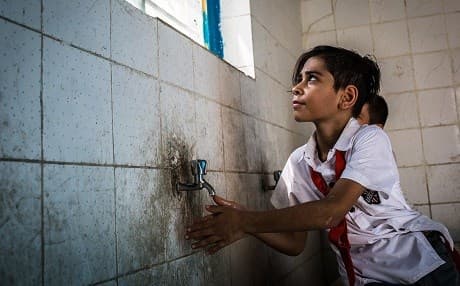 A child washes his hands at Faihaa school in Basra’s old city. Water runs for just two hours a day and is not drinkable. Photo: Tom Peyre-Costa/NRC