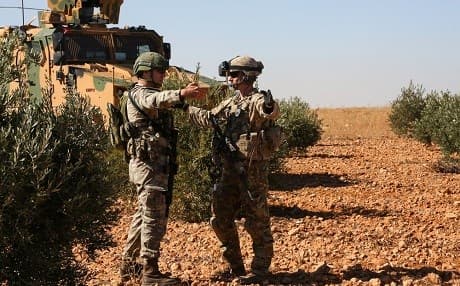 US and Turkish soldiers discuss details during the first-ever combined joint patrol on November 1, 2018, in Manbij, Syria. Photo: SPC Arnada Jones/US Army