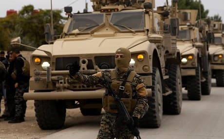 Members of the Syrian Democratic Forces and US soldiers patrol the Kurdish-held town of al-Darbasiyah in northeastern Syria bordering Turkey on November 4, 2018. Photo: Delil Souleiman | AFP