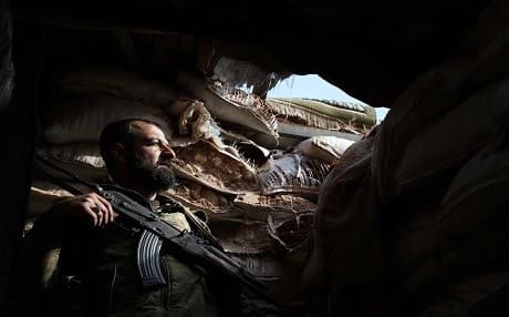 A Syrian rebel-fighter from the National Liberation Front takes position on the frontline facing government forces in the al-Rashedin area west of Aleppo in northwestern Syria, on November 20, 2018. Photo: Aaref Watad | AFP
