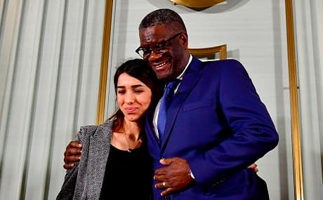 Nobel Peace Prize laureates Congolese doctor Denis Mukwege (R) and Yezidi activist Nadia Murad (L) hug at the end of a press conference in Oslo, December 9, 2018. Photo: Tobias Schwarz / AFP