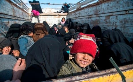 Women and children fleeing from the last Islamic State group's tiny pocket in Syria sit in the back of a truck near Baghouz, eastern Syria, on February 11, 2019. Photo: Fadel Senna/AFP