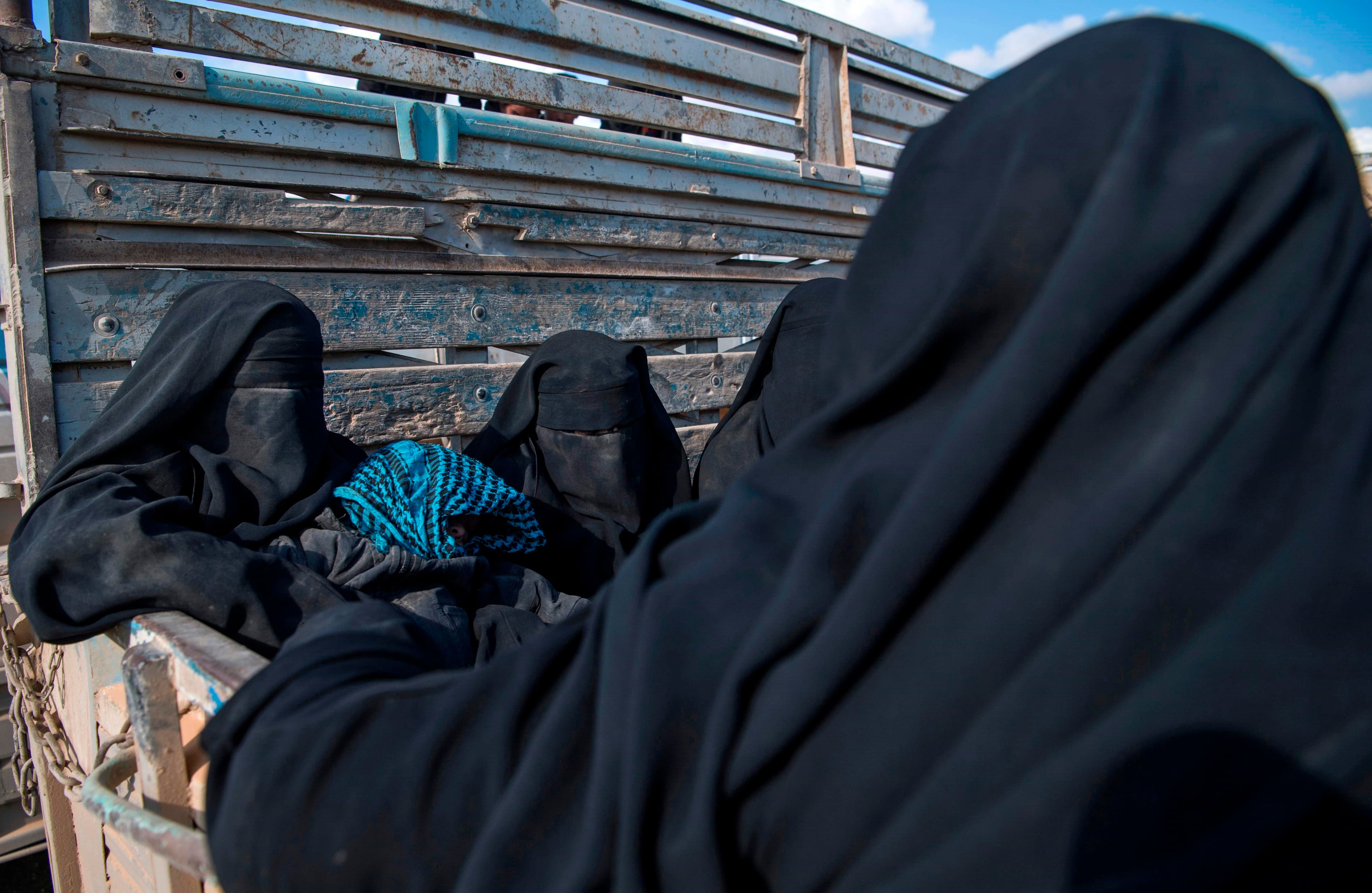 Women and children fleeing from the last Islamic State group's tiny pocket in Syria sit in the back of a truck near Baghuz, eastern Syria, on February 11, 2019. Photo: Fadel Senna | AFP