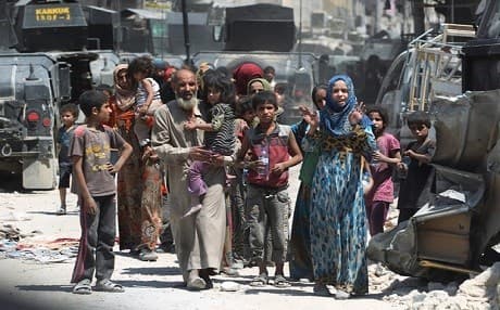 Iraqi forces evacuate civilians fleeing Mosul's Old City during the battle to retake the western side of the city in mid 2017. AFP file photo