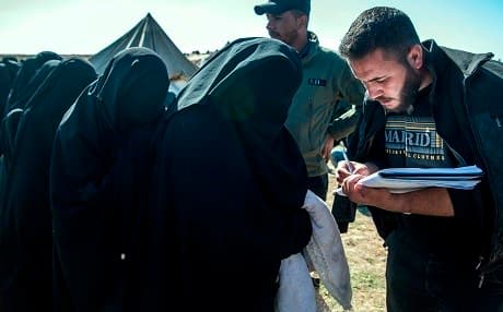 Women fleing from al-Baghouz, Syria, give their names to Syrian Democratic Forces on February 12, 2019. Photo: Fadel Senna | AFP