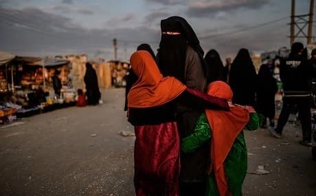 A veiled woman looks back at al-Hol camp in al-Hasakeh governorate in northeastern Syria on February 17, 2019. Photo: Bulent Kilic | AFP 