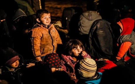 Women and children evacuated from the ISIS holdout of al-Baghouz wait in a zone held by the SDF on February 25, 2019. Photos: Delil Souleiman | AFP