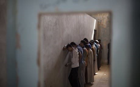 Men displaced from Hawija face a wall at a Kurdish screening centre in Dibis, Iraq on October 3, 2017 as authorities determine if they were associated with ISIS. File photo: Bram Janssen/AP