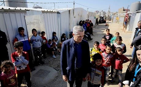 Filippo Grandi (C), the United Nations High Commissioner for Refugees, meets with Syrian refugee children at a camp in the village of Mhammara in the northern Lebanese Akkar region, March 9, 2019. Photo: Ibrahim Chalhoub / AFP