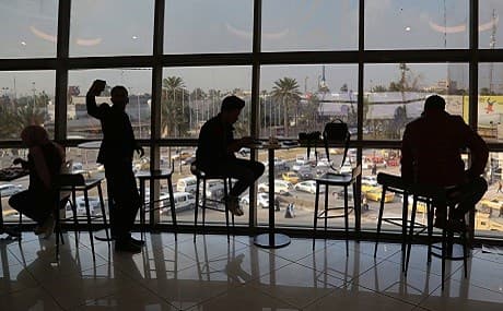 People eat in a restaurant at a shopping mall in Baghdad, Iraq, February 11, 2019. Photo: Khalid Mohammed / AP