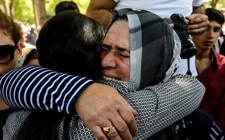Two women embrace during a funeral for a victim of a suicide bombing of a Kurdish wedding in Gaziantep that killed 57 people. File photo: Ilyas Akengin/AFP