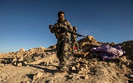 SDF hold a position on a hilltop overlooking the ISIS tent camp in Baghouz on March 18, 2019. Photo: Delil Souleiman/AFP