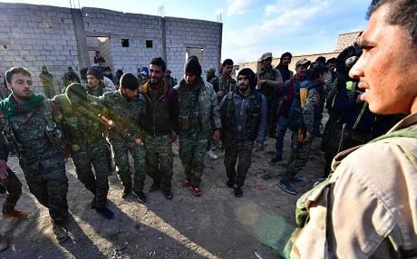 SDF fighters celebrate as they come back from the frontline against ISIS in Baghouz on March 19, 2019. Photo: Giuseppe Cacace/AFP