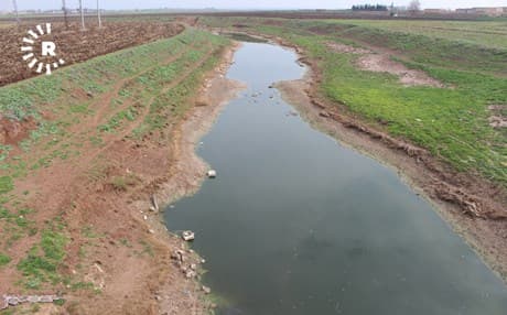 The polluted water of Khabur Deresi cuts through fields on the southwestern edge of Sari Kani on February 23, 2019. Photo: Hannah Lynch/Rudaw