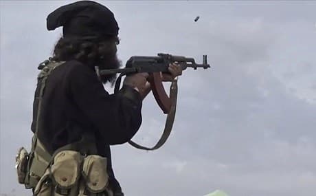An ISIS fighter fires his weapon during clashes with the US-backed SDF in Baghouz, Syria, March 18, 2019. Photo: ISIS-affiliated Aamaq News Agency / AP