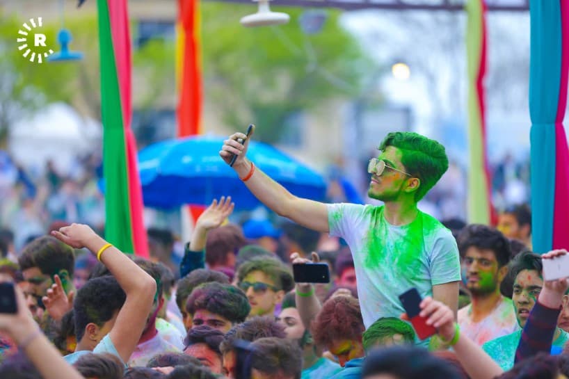 Erbil festival-goers party under a rainbow cloud