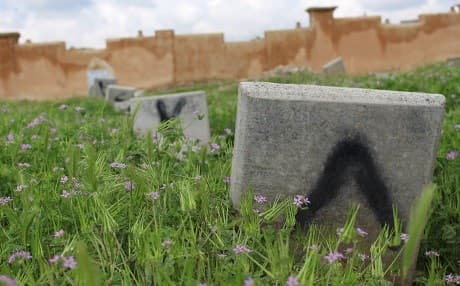 A stone slab simply labelled 'eight' marks a grave in the Forensic Department section of a graveyard in Erbil's Kasnazan neighbourhood on April 17, 2019. Here are buried the men, women, and children unclaimed or abandoned by their families. Photo: Hannah Lynch / Rudaw
