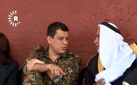 Mazlum Kobane, commander of the Syrian Democratic Forces (left) speaks with an Arab tribal leader at a forum in Ain Issa on May 3, 2019. Photo: Rudaw