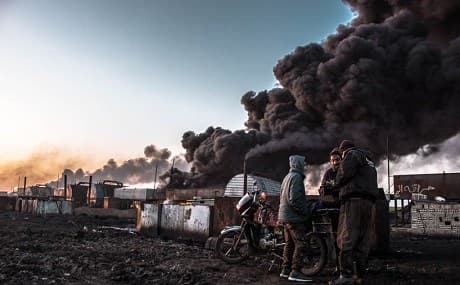 Black smoke spews from a ramshackle oil refinery in Kurdish-controlled northeast Syria. File photo: Hannah Lynch / Rudaw 