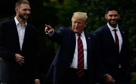 Accompanied by pitcher Chris Sale (L) and right fielder J.D. Martinez (R), U.S. President Donald Trump (C), arrives at a South Lawn event to honor the Boston Red Sox May 9, 2019 in Washington, DC. Photo: Alex Wong/Getty Images/AFP