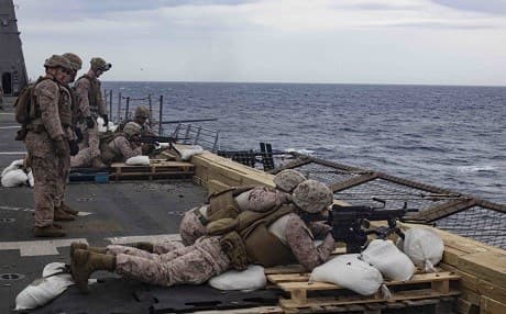 US Marines fire 249 Squad Automatic Weapons (SAW) during a live-fire exercise on the flight deck of the San Antonio-class amphibious transport dock ship USS Arlington (LPD 24), on May 3, 2019 in the Mediterranean Sea. Photo: Mass Communication Specialist 2nd Class Brandon Parker/US Navy