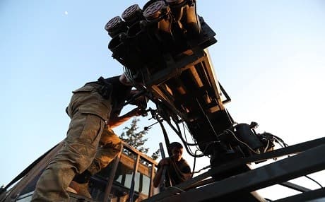 Syrian fighters from the Turkish-backed National Liberation Front (NLF) prepare to fire missiles against regime positions on May 13, 2019 in the rebel-held northern part of Syria's Hama province. Photo: Omar Haj Kadour | AFP