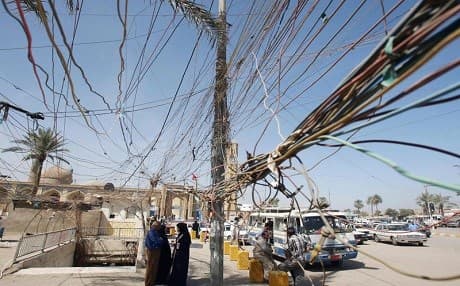 A mess of electrical wires hangs from utility poles in front of the Abu Hanifa mosque in Baghdad's al-Adhamiyah district in March 2008. File photo: Patrick Baz | AFP 