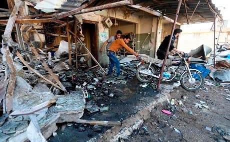 Syrians remove a motorcycle from the site of regime bombardment on the village of Kafr Halab, western edge of Aleppo province, May 28, 2019. Photo: Omar Haj Kadour
