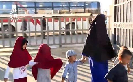 Uzbek women and children are handed over by YPJ troops in al-Jazeera, northern Syria, May 29, 2019. Photo: Rudaw video