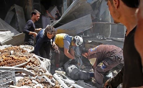 Members of the Syrian Civil Defence (known as the White Helmets) evacuate a wounded man from under the rubble following a reported airstrike on the town of Maaret al-Numan in the jihadist-held Idlib province, June 3, 2019. Photo: Abdulaziz Ketaz / AFP 