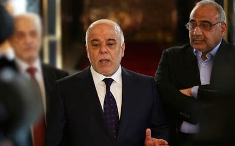 Then-Iraqi Prime Minister Haidar al-Abadi (C) speaks to reporters next to then-Oil Minister Adil Abdul-Mahdi. File photo: Khalid Mohammed / AP