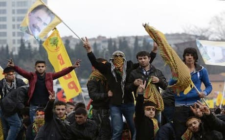 Kurds in Diyarbakir city wave pictures of jailed PKK leader Abdullah Ocalan a few days before his peace declaration on March 21. Photo: AP