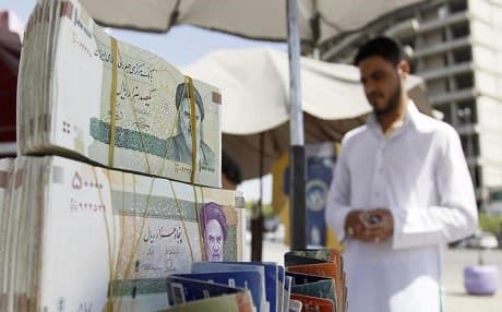 An Iraqi vendor sells Iranian currency in a street in Najaf. File photo: AFP