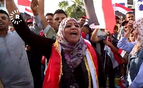 Rana Hamid (C) is accused of violating the Iraqi constitution by praising Saddam Hussein and the Baathist ideology during a protest in Kirkuk on Friday, July 12, 2019. Photo: Rudaw TV / submitted 